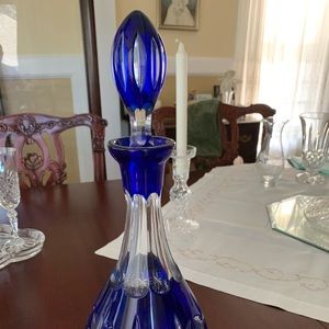Blue wine decanter with 9 wine glasses.